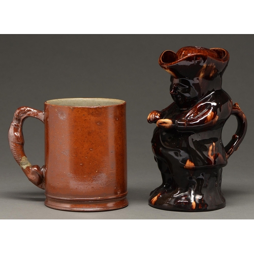 432 - An English saltglazed brown stoneware quart frog mug, mid 19th c and a treacle brown glazed earthenw... 