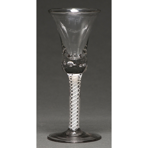 493 - A George III wine glass,  the bell bowl with solid base with tears, on double series opaque twi... 