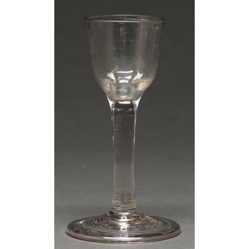 495 - A George II wine glass,   the ogee bowl on plain stem and folded foot, 14cm h... 