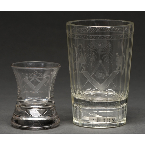 496 - Freemasonry.  A faceted glass beaker, wheel engraved with masonic emblems, the base containing three... 