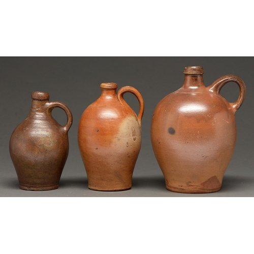 517 - Three German saltglazed brown stoneware bottles or jugs, Rhineland, second-half 17th-18th c, glazed ... 