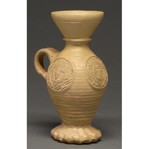 520 - A German stoneware wine jug, Siegburg, Rhineland, elements c. 1550-75, with three portrait... 