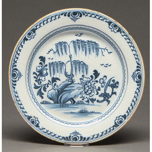 525 - An English Delft ware plate, probably London, mid-18th c, typically painted in underglaze blue with ... 