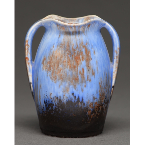 543 - An art pottery two-handled vase, in the style of Ruskin, c.1900, glazed in blue, black, and brown, 1... 