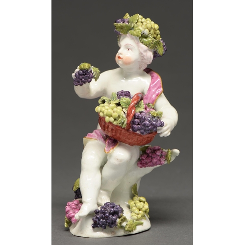 553 - A Derby figure of a Bacchic putto, c. 1765, holding a basket of grapes, his head crowned by a confor... 