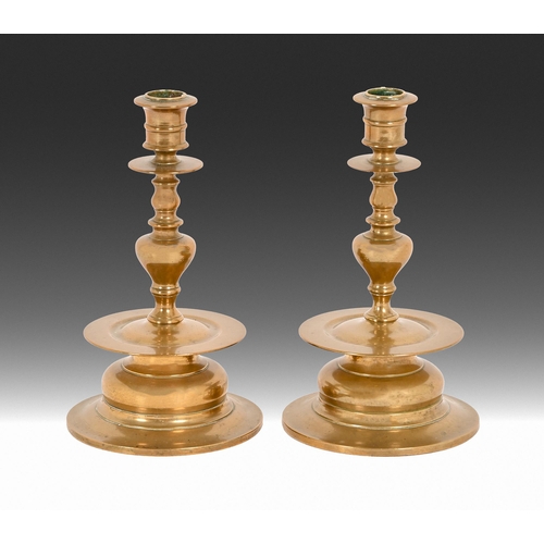 667 - A pair of Swedish turned brass Skultuna no.58 candlesticks, mid 20th c, impressed marks, 21cm h... 