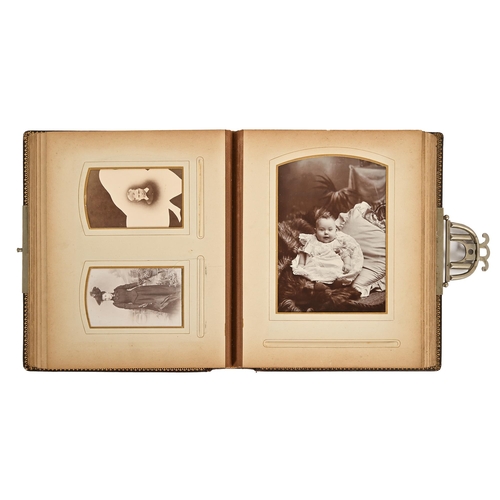 683 - A late Victorian embossed leather photograph album, containing portraits and family photographs, ste... 