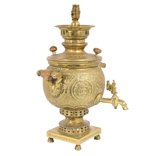 696 - A Middle Eastern embossed brass samovar, early 20th c, with twin turned wood handles, adapted as a t... 