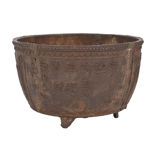 710 - A cast iron tripod censer, 17th c the exterior  with Chinese calligraphy and  arabesque type panels,... 