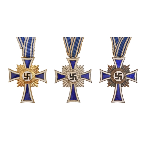 750 - Germany, Third Reich, Mother's Cross, three, one cased and a helmet