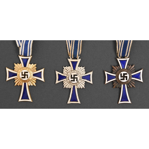 750 - Germany, Third Reich, Mother's Cross, three, one cased and a helmet