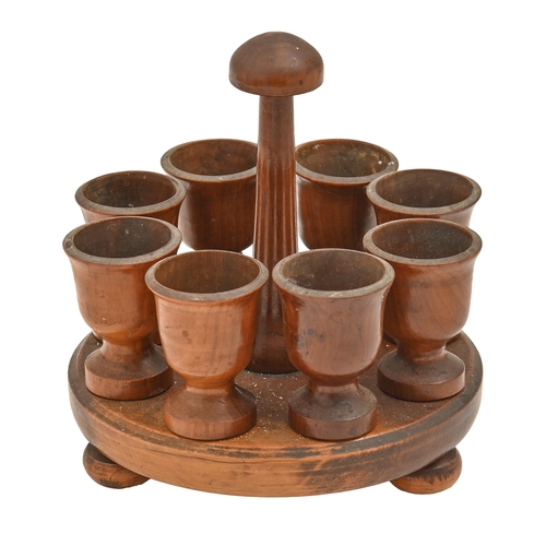 833 - A set of eight turned yew wood eggcups and stand, Victorian or early 20th c, 18cm h