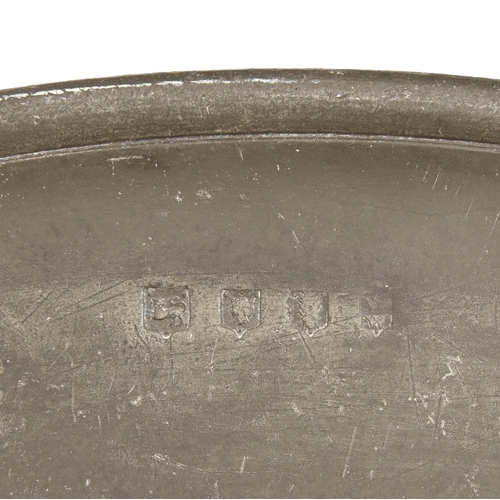 859 - Three English pewter charges, late 18th c and later,  46 and 51.5cm diam