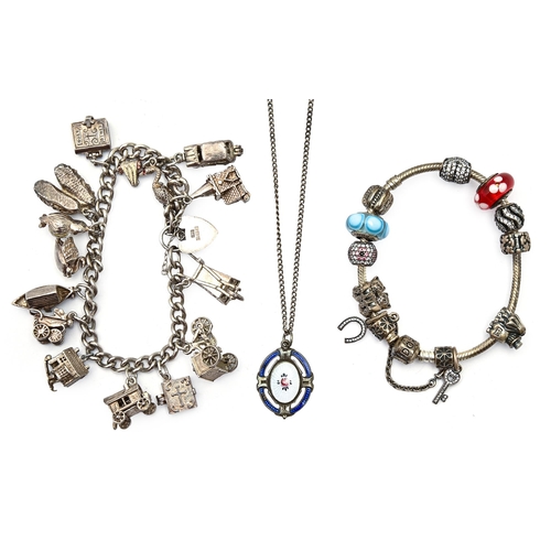 91 - A silver charm bracelet, an oval silver and enamel pendant and necklet and a Pandora bracelet... 