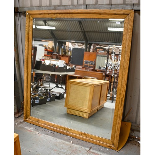 1343 - An oak framed overmantle mirror with bevelled plate, 132cm x 153cm