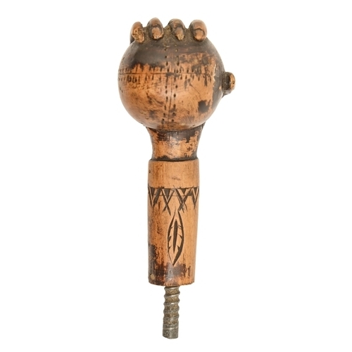 822 - An American carved and stained wood walking cane handle, early 20th c, in the form of a hand holding... 