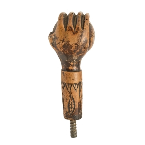 822 - An American carved and stained wood walking cane handle, early 20th c, in the form of a hand holding... 