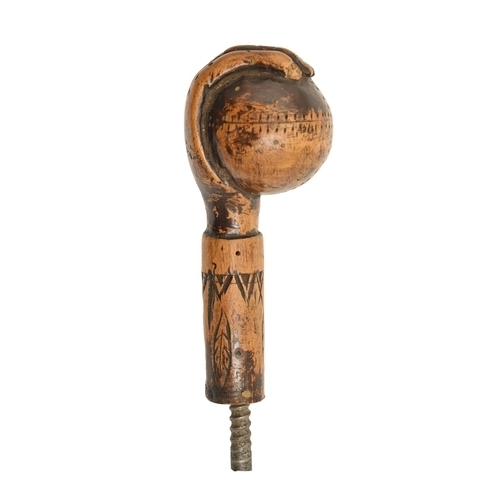 822 - An American carved and stained wood walking cane handle, early 20th c, in the form of a hand holding... 