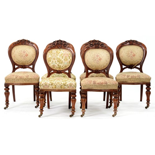 1179 - A set of six Victorian walnut balloon back dining chairs, the strapwork cresting to the padded back ... 