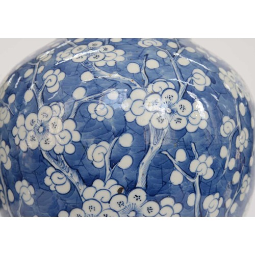 390 - A Chinese blue and white ginger jar and a cover, 19th c, painted with prunus on a cracked ice ground... 