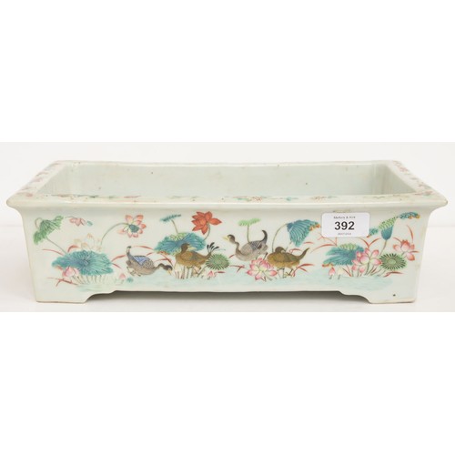 392 - A Chinese famille rose rectangular jardiniere, 19th c, painted with wading and other birds, lotus an... 