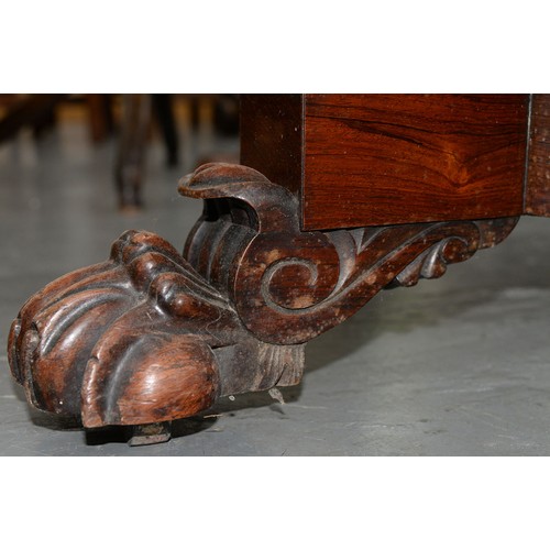 1182 - A Victorian rosewood library table, fitted with two drawers and opposing blind drawers, on four feet... 