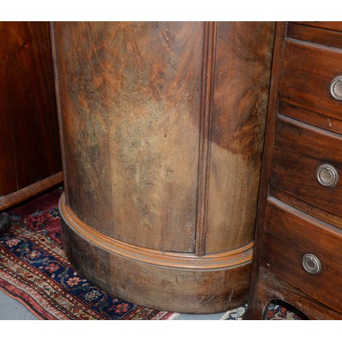 1227 - A Northern European Biedermeier style mahogany cupboard, 19th c, of oval section, the curved door is... 