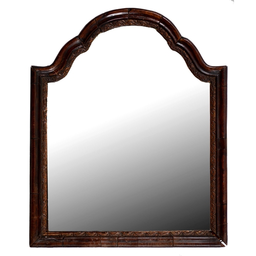 805 - A walnut mirror, late 19th c, in George I style, the shaped and arched, moulded frame with giltwood ... 