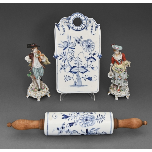 111 - A Schoenau Brothers blue and white Meissen Onion pattern cutting board and wood-handled rolling pin,... 