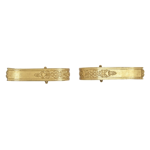 573 - A pair of gilt lacquered brass curtain tie backs, in Empire style, and wall mounts (4)... 