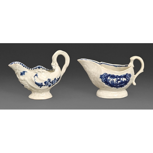 67 - Two blue and white creamware butter boats, late 18th c, with biting snake handles, the tallest 9.2cm... 