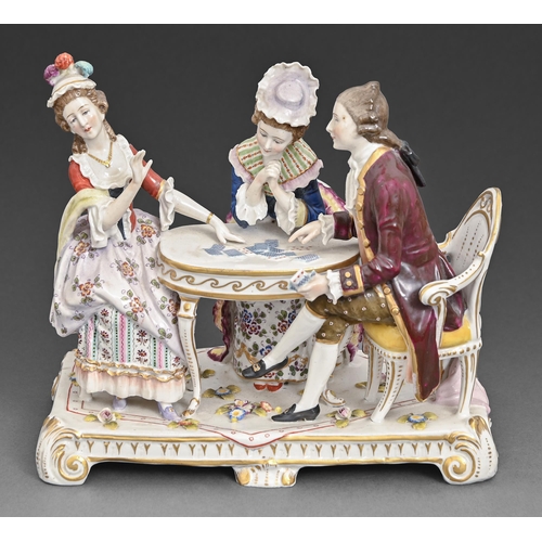 69 - A continental porcelain group of two women and a man around a card table, late 19th c, 21.5cm h, blu... 