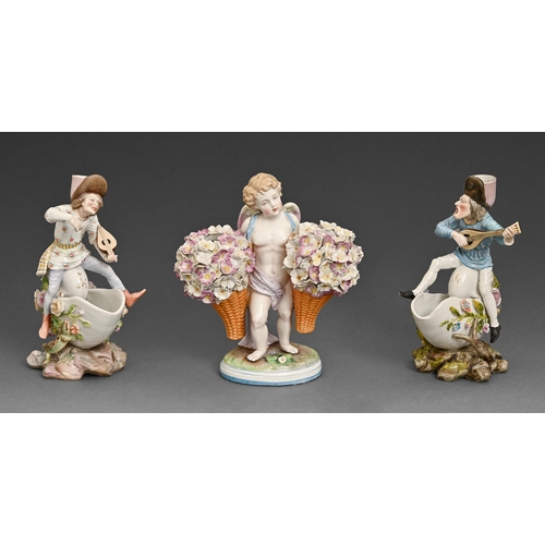 70 - A pair of continental porcelain figural candlesticks, 19th c, sat astride shells and a flower vase i... 