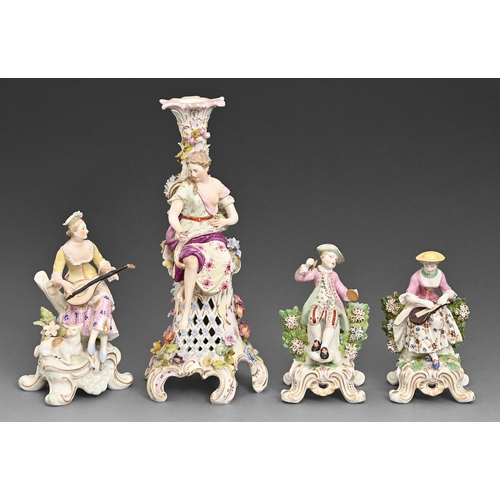 71 - A Continental porcelain figural candlestick, a pair of musician figures and a figure of a woman with... 