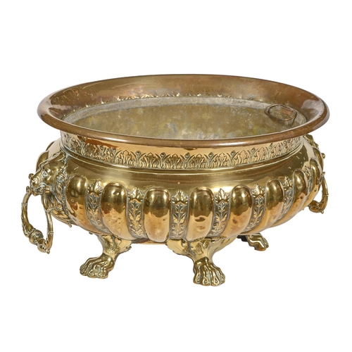 849 - A brass jardiniere or wine cistern, c1900, in Dutch 17th c style, with lion mask handles on cast paw... 