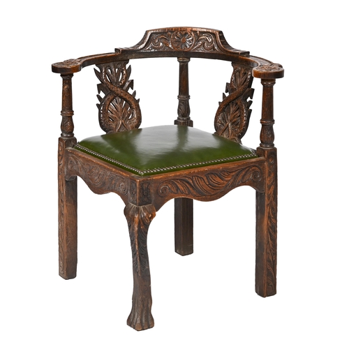 856 - A Victorian carved oak corner chair, with two entwined dolphin splats, 77cm h