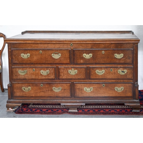 895 - A George III oak and crossbanded 'Lancashire' chest, the lid opening to reveal a till, 94cm h; 54 x ... 