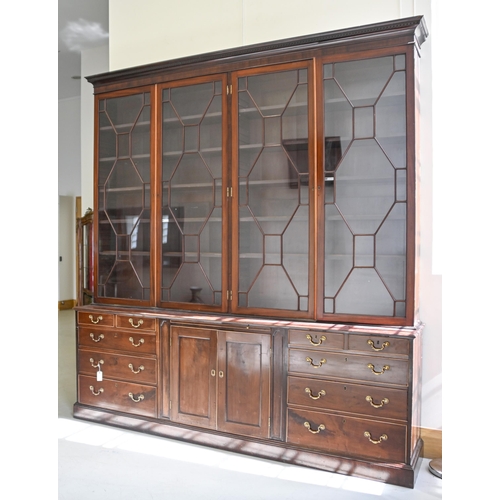 900 - A mahogany library bookcase, 20th c, with dentil cornice above four glazed doors enclosing adjustabl... 