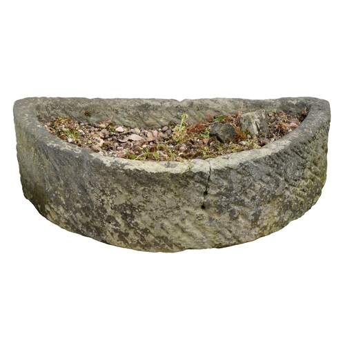 907 - Garden ornaments. A Victorian semi-circular grit stone trough, 21cm h; 41 x 77cm