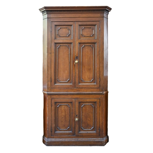 933 - A George III painted pine standing corner cupboard, with stepped pediment and dentil cornice, the up... 