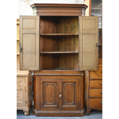 933 - A George III painted pine standing corner cupboard, with stepped pediment and dentil cornice, the up... 