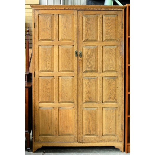 945 - An oak wardrobe, with raised and fielded door-panels and oak five-panelled sides, 176cm h; 56 x 111c... 