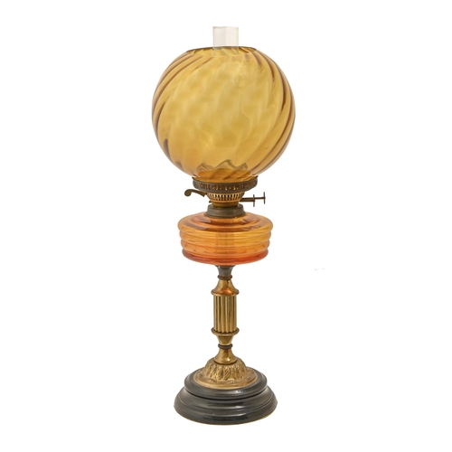 740 - A Victorian brass oil lamp, on ebonised base, with amber glass font and globular shade, twin duplex ... 