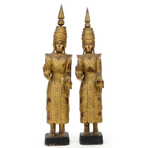 1003 - A pair of carved and gilded hardwood statues of a Bodhisattva, Thailand, 20th c, the elaborate costu... 