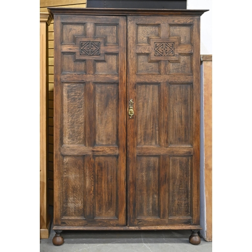 1011 - An oak wardrobe,  with geometric panelled doors, c1920, 184cm h, 124cm l