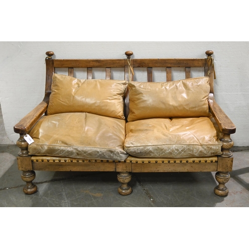 1025 - A distress walnut or similar wood and brass nailed hide three piece suite, sofa 120cm l, feather cus... 