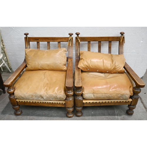 1025 - A distress walnut or similar wood and brass nailed hide three piece suite, sofa 120cm l, feather cus... 