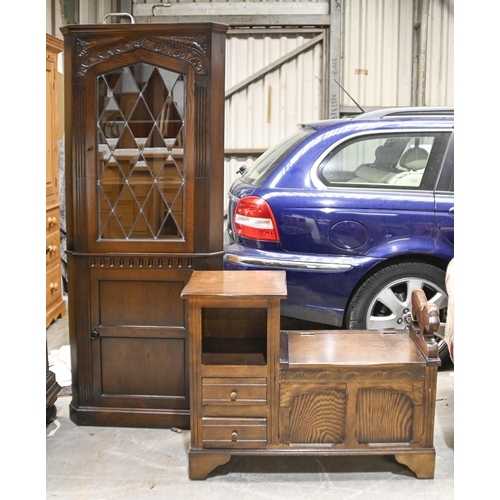 1041 - A reproduction stained telephone seat, 90cm l and a carved and dark stained oak standing corner cabi... 