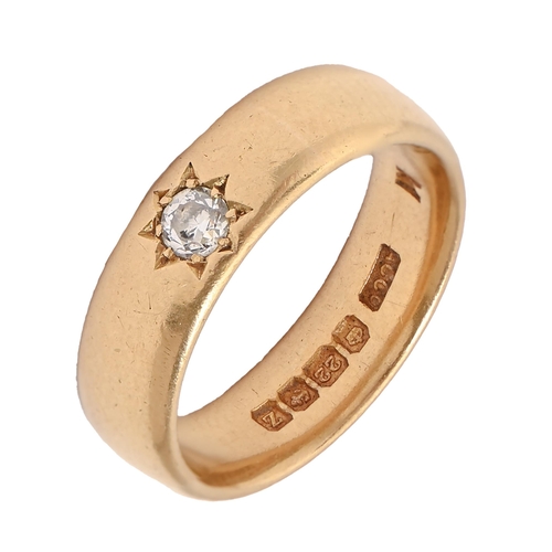 22 - A diamond ring, with a single old cut diamond, set in a 22ct gold wedding ring, Birmingham 1924, 7.1... 