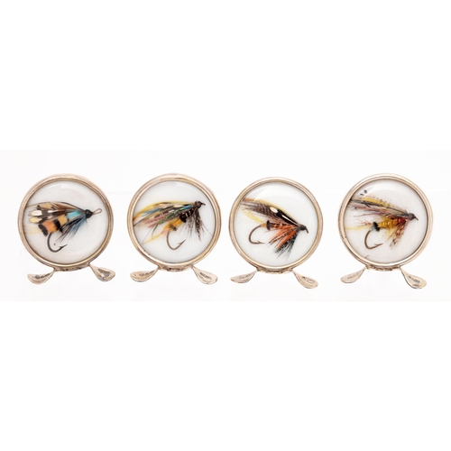 265 - Fly-fishing. A set of George V silver fishing fly novelty place stands, on three feet, 46mm h, by Gr... 